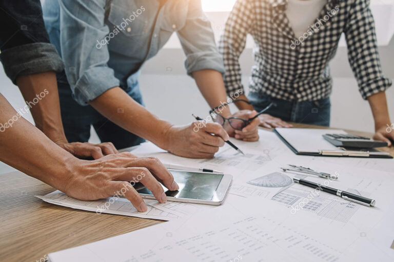 depositphotos 291077932 stock photo engineers discuss a blueprint while